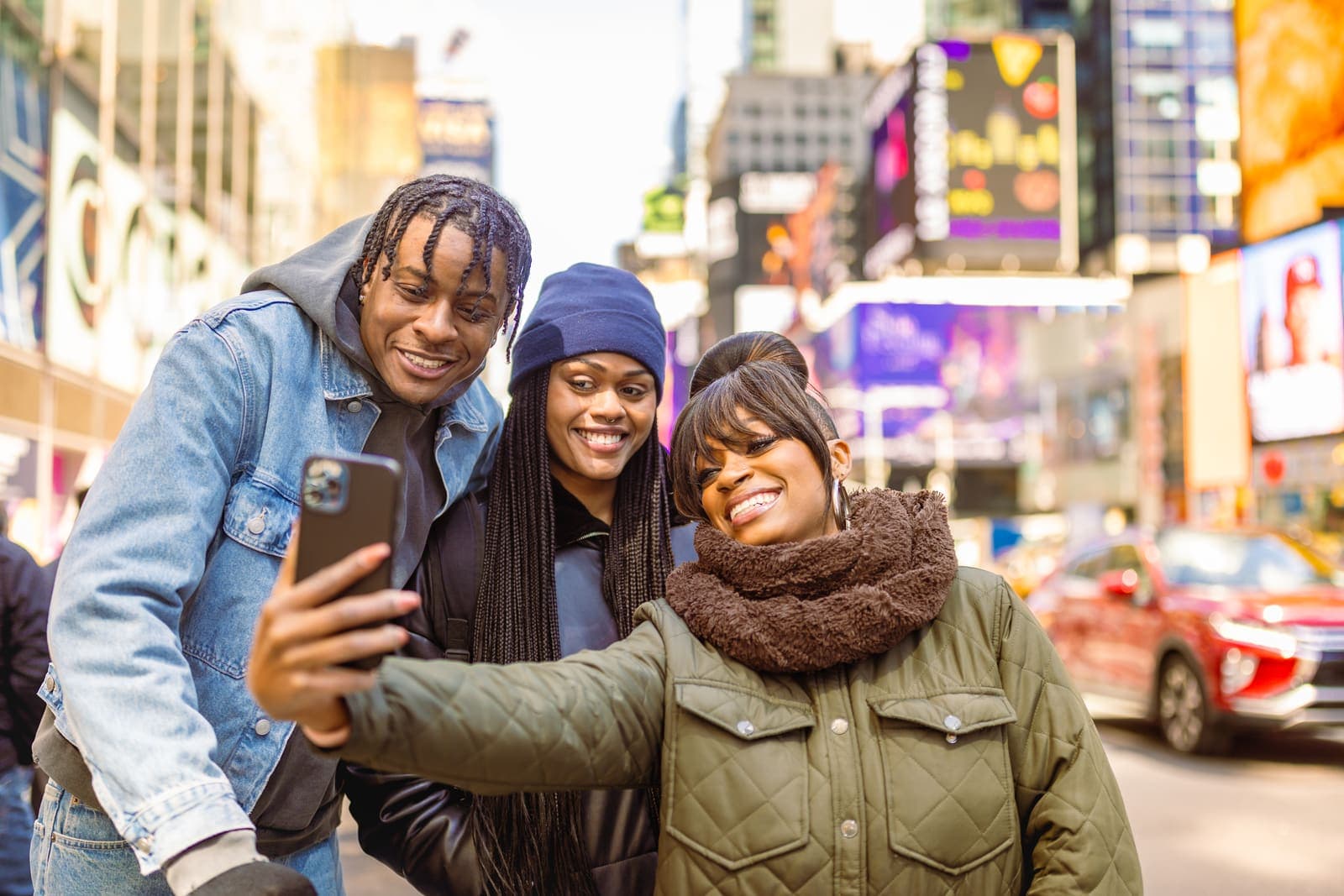 Stock photo tagged for two agencies — friends taking a selfie in Times Square